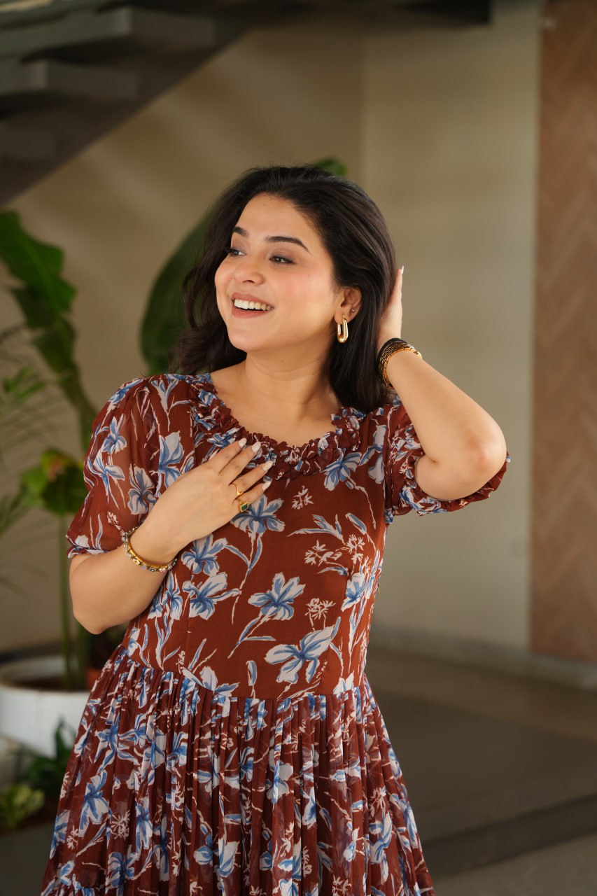 Vikarni Brown Printed Anarkali Gown in faux georgette with 12-meter flair & cotton lining – perfect for haldi, mehndi, festive & Indo-western occasions.