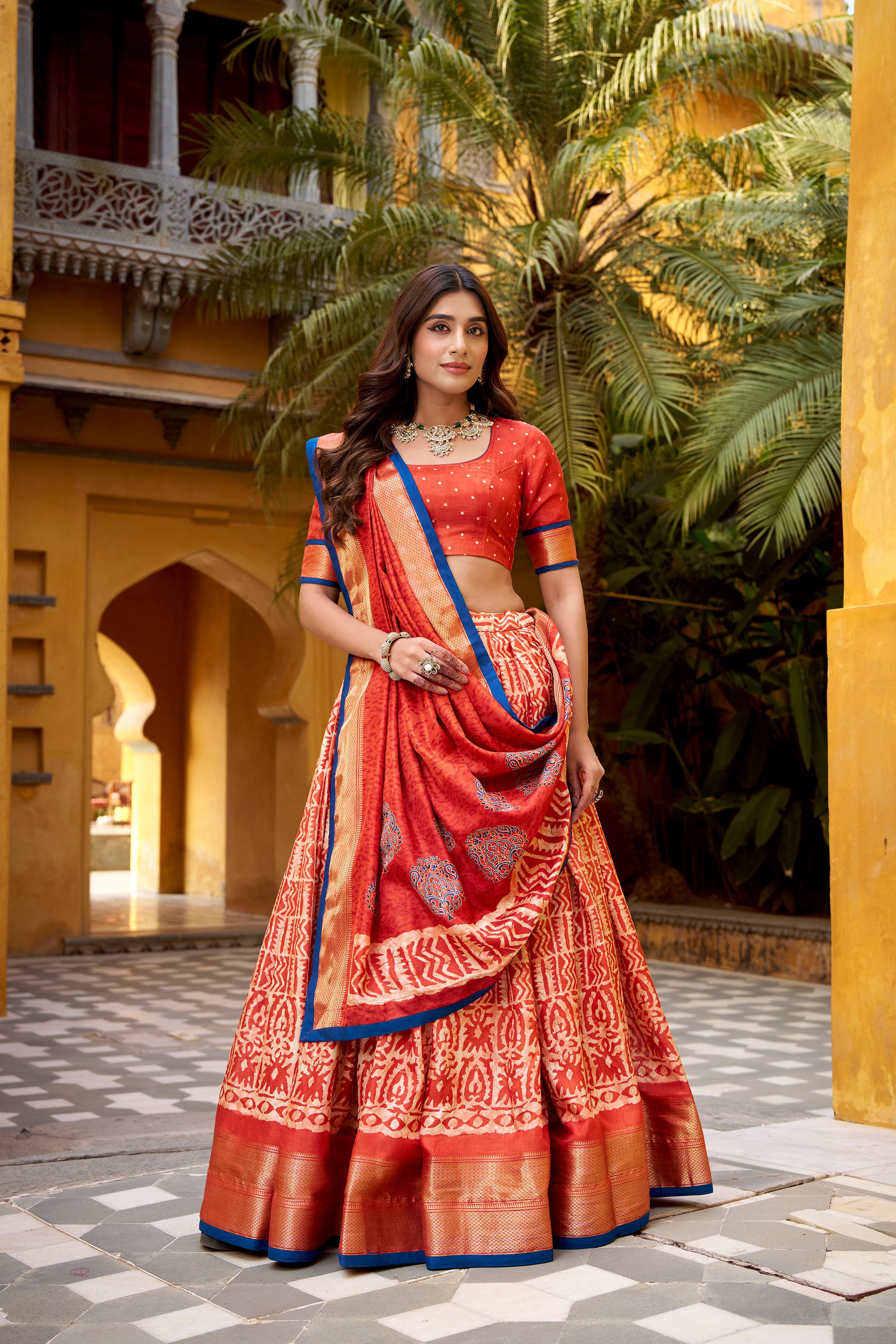 Girija Rust Orange Dola Silk Batik Print With Zari
Weaving Work Lehenga Choli