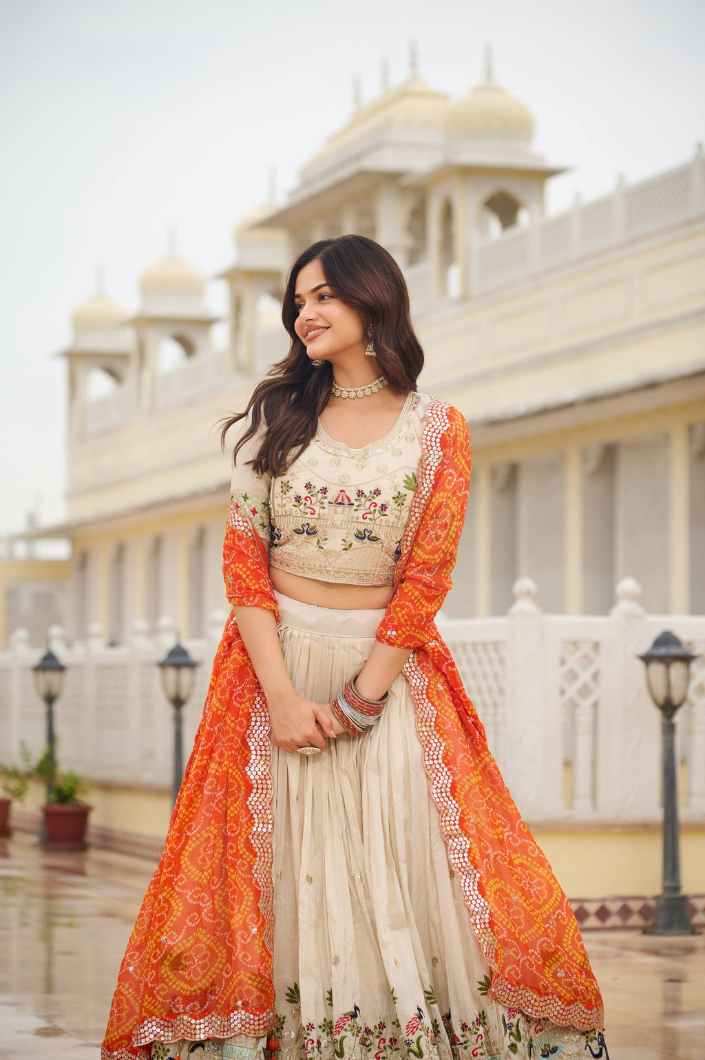 Off-white silk sequins thread embroidery lehenga choli with orange Bandhej dupatta