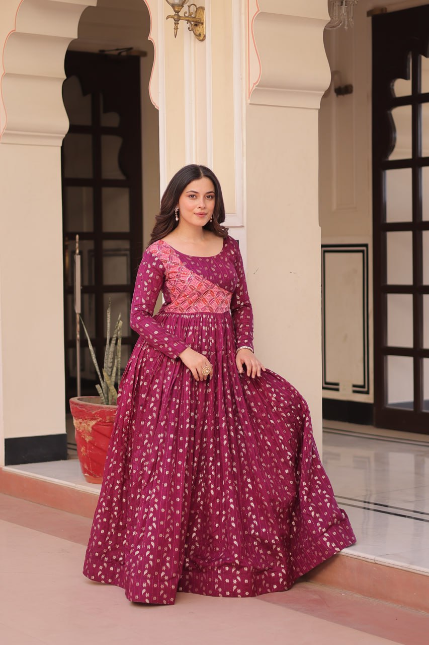 Vani Choli Printed Wine Color Gown with staple jacquard fabric, full sleeves, cotton lining, and 3-meter flare – perfect ethnic party wear gown for wedding functions, festive nights, and modern Indian women.