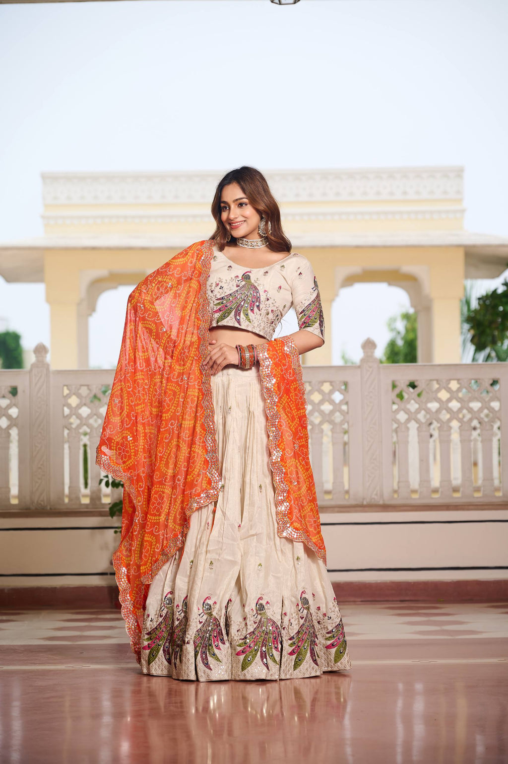 Amla off-white tissue silk lehenga choli with sequins thread work and orange Bandhej dupatta