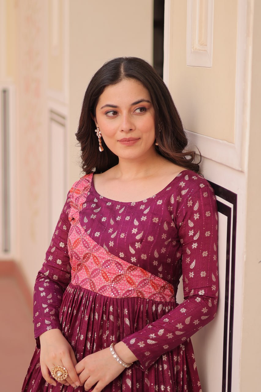 Vani Choli Printed Wine Color Gown with staple jacquard fabric, full sleeves, cotton lining, and 3-meter flare – perfect ethnic party wear gown for wedding functions, festive nights, and modern Indian women.