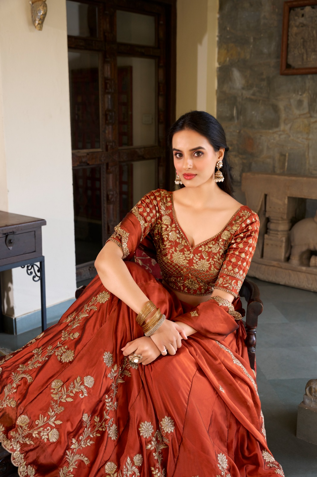 Rust orange rangoli silk lehenga choli with embroidered sequins work